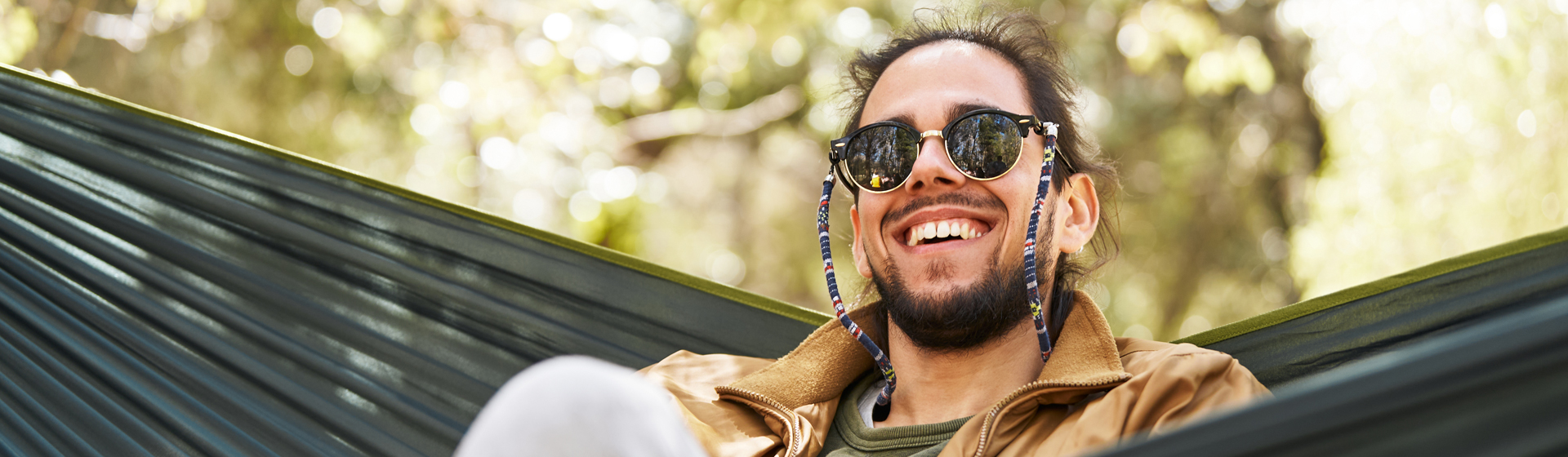 Man smiling in a hammock