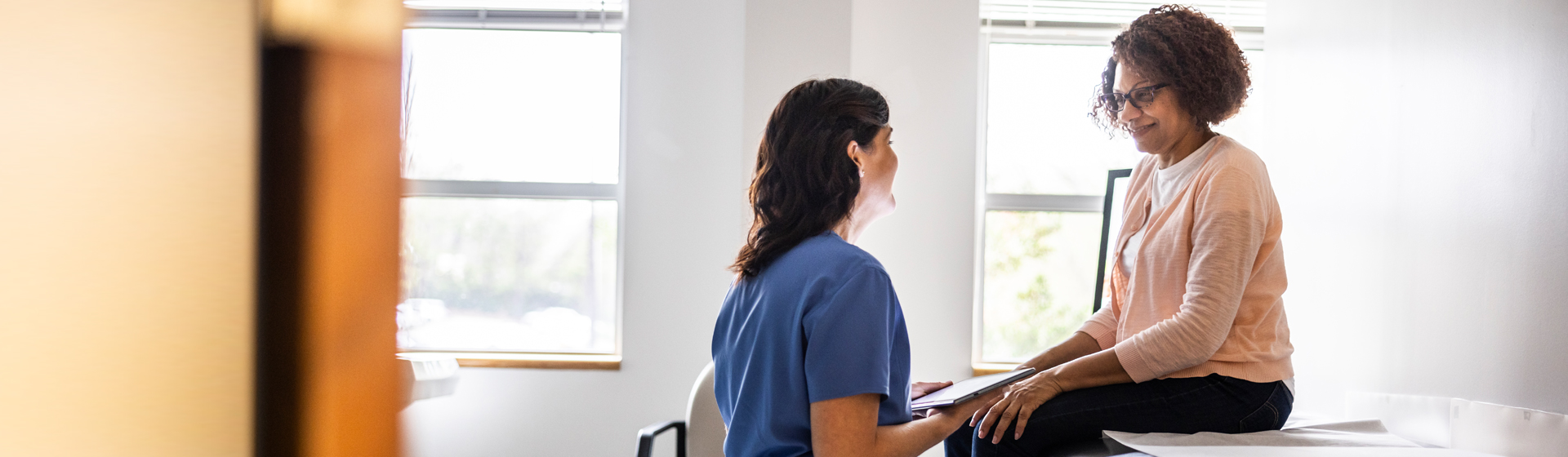 Female patient talking to a female healthcare worker