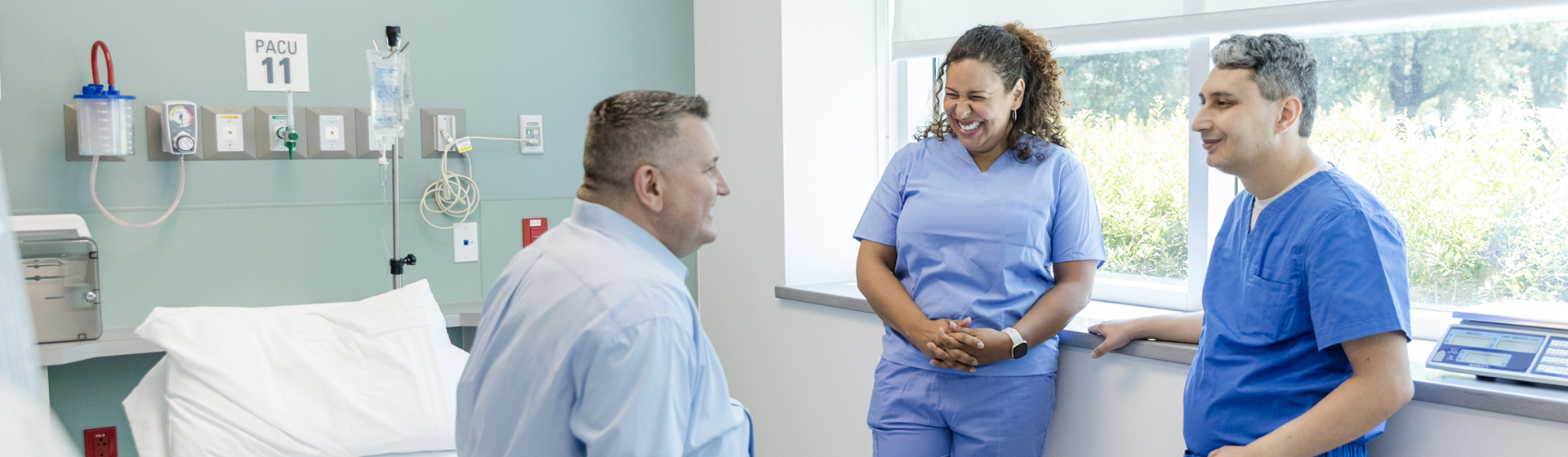 Healthcare professionals smile as they listen to their patient