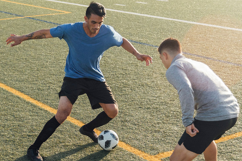 Two men playing soccer