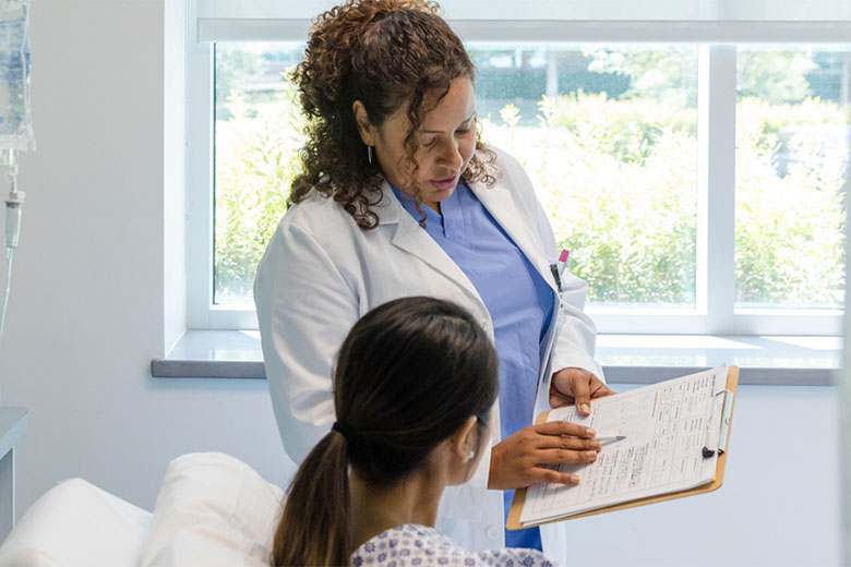 Female doctor shows her patient the medical test results