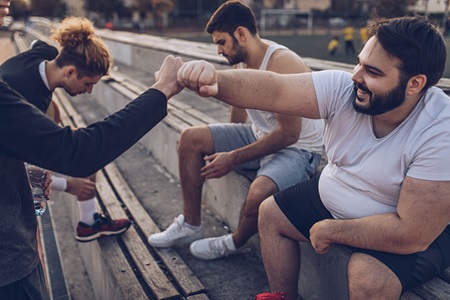 Men sitting on bleachers